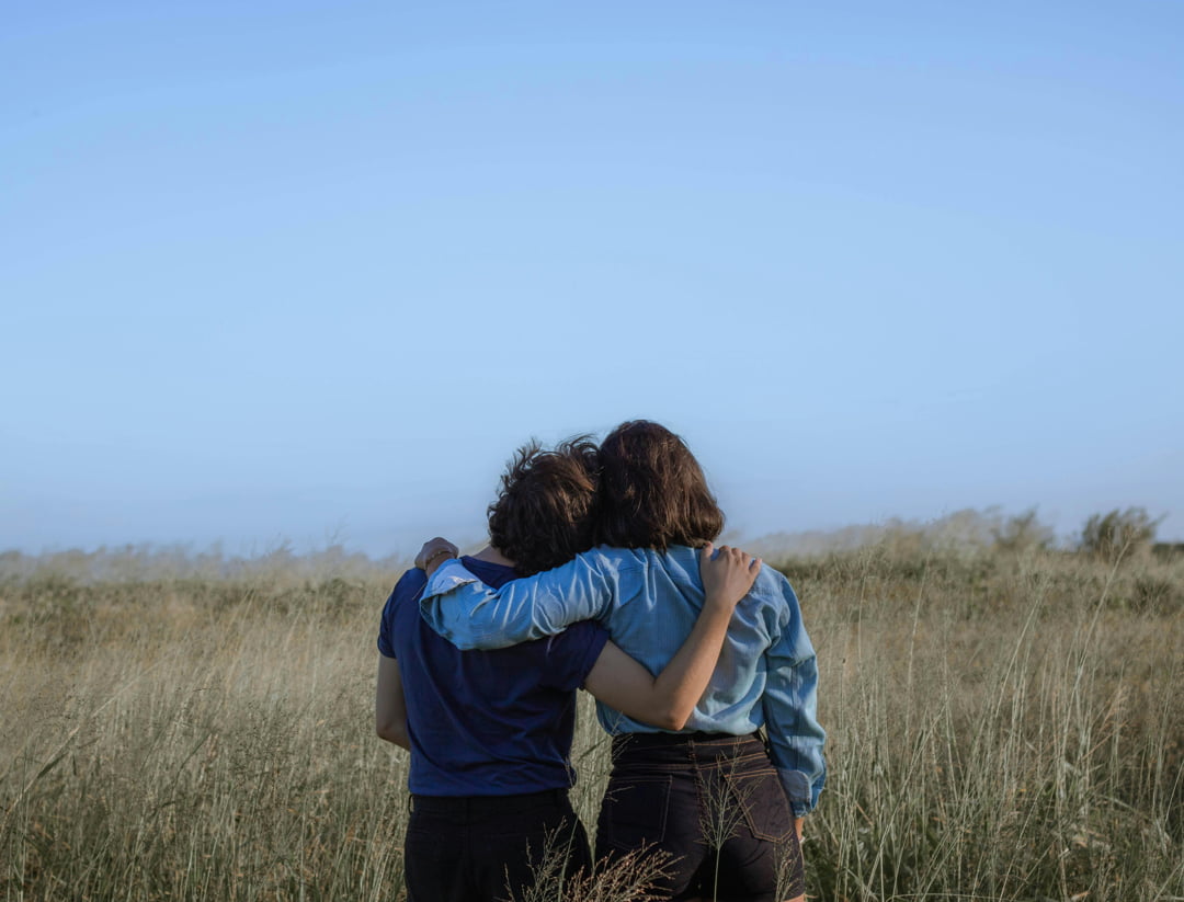 2 girls looking at a view of a meadow