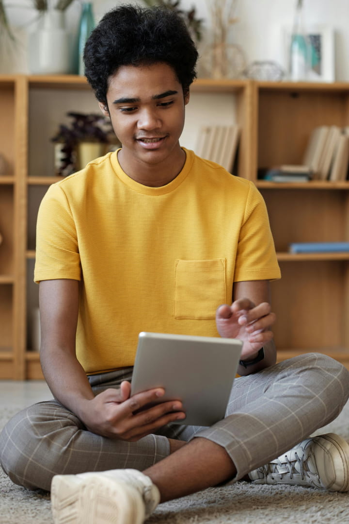 a teen working on his tablet