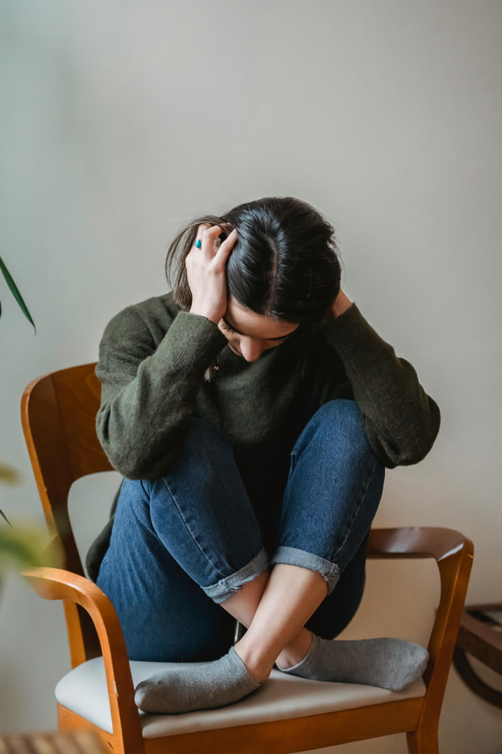 a girl crouched on her chair